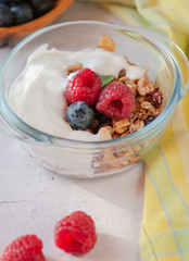 dry breakfast of granola and wild berries. Delivered in a glass plate