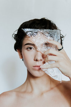 portrait photo of woman holding glass panel