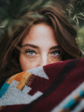 selective focus photography of woman covering her mouth