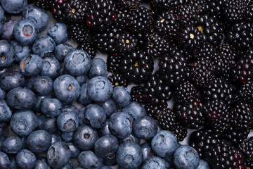 Mix berries and fruits. The view from the top. Background berries are diagonally Black-blue and red food.