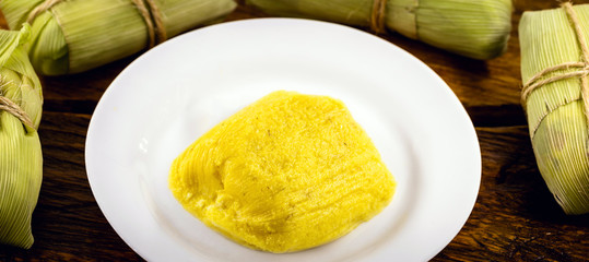 pamonha, Brazilian sweet made from homemade cheese with corn. Open pissing ready for consumption. Concept of traditional Brazilian sweet, typical food of the months of June and July.