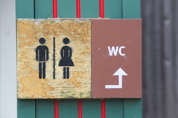 A toilet sign in a public park