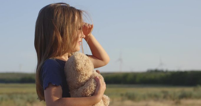 Girl looking around in field