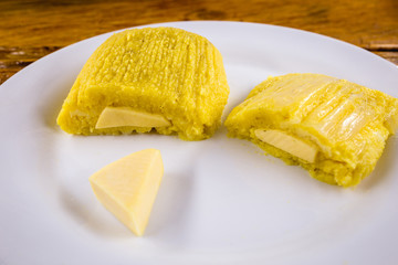 pamonha, Brazilian sweet made from homemade cheese with corn. Open pissing ready for consumption....