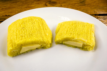 pamonha, Brazilian sweet made from homemade cheese with corn. Open pissing ready for consumption. Concept of traditional Brazilian sweet, typical food of the months of June and July.