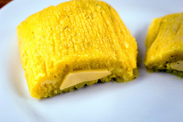 pamonha, Brazilian sweet made from homemade cheese with corn. Open pissing ready for consumption. Concept of traditional Brazilian sweet, typical food of the months of June and July.