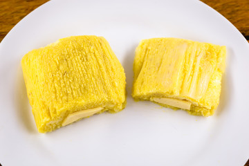 pamonha, Brazilian sweet made from homemade cheese with corn. Open pissing ready for consumption....
