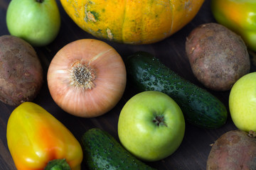 fresh fruits and vegetables. Pumpkin, onion, apple, cucumber and green pepper on wooden background.