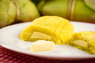 pamonha, Brazilian sweet made from homemade cheese with corn. Open pissing ready for consumption. Concept of traditional Brazilian sweet, typical food of the months of June and July.