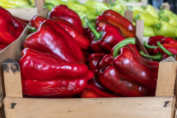 Giant Red Peppers Arranged in Wooden Crate Closeup View From Side