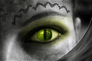Part of a woman's face in black and white color. Green glowing eye.