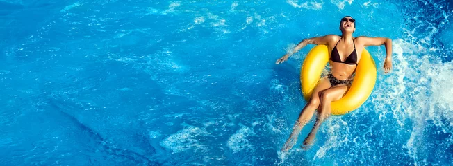 Fotobehang Summer vacation. Laughing young woman enjoying an aqua park. Fun in the pool © Casther
