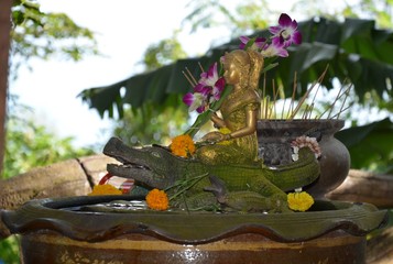 buddhistic figurine of woman on a crocodile