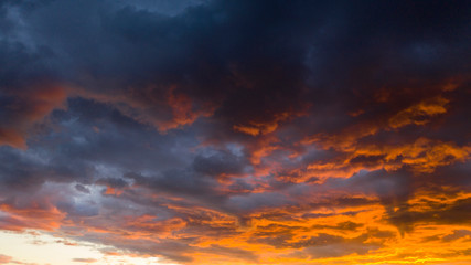 Fototapeta na wymiar Fire Orange Sunset With Blue Cloud Background