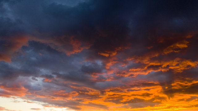 Fire Orange Sunset With Blue Cloud Background