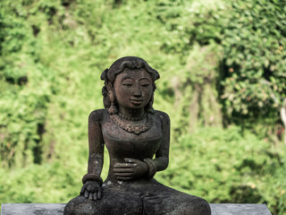traditional statue head of a women made of stone in Bali, Indonesia