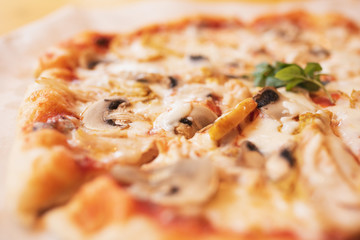 Pizza with chicken and mushrooms close-up in defocus