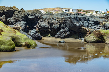 Beautiful natural southern coastline with wildlife, rocks and beaches near El Medano. Sunny day, gentle sea surf. Travel photo, postcard. Tenerife, Canary Islands