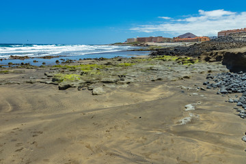 Beautiful natural southern coastline with wildlife, rocks and beaches near El Medano. Sunny day, blue sky and white fluffy clouds above the horizon. Travel photo, postcard. Tenerife, Canary Islands