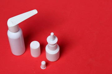 White spray nasal and oral spray. Against the background of coral color. View from above.