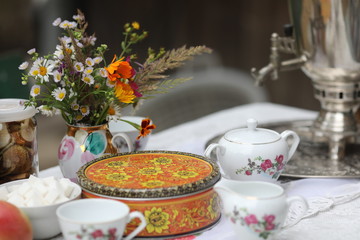 Russian tea ceremony with samovar and sweets and fruits