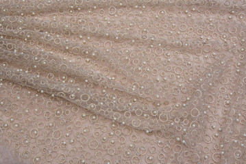 Texture lace fabric. lace on white background studio. thin fabric made of yarn or thread. a background image of ivory-colored lace cloth. Beige lace on beige background.