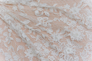 Texture lace fabric. lace on white background studio. thin fabric made of yarn or thread. a background image of ivory-colored lace cloth. White lace on beige background.