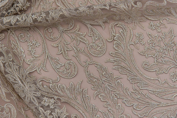 Texture lace fabric. lace on white background studio. thin fabric made of yarn or thread. a background image of ivory-colored lace cloth. Beige lace on beige background.