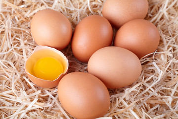beautiful chicken eggs on hay, homemade farm natural product, broken egg yolk