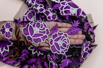 Texture lace fabric. lace on white background studio. thin fabric made of yarn or thread. a background image of ivory-colored lace cloth. Purple lace on beige background.