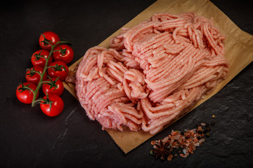 top view of raw minced meat with spices and tomatoes