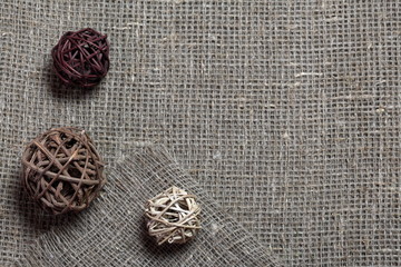 Coarse linen fabric. On it are rattan balls.