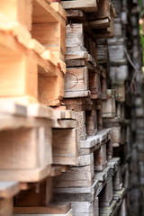 wooden pallets stacked high on top of each other in a companys factory yard in london no people stock photo