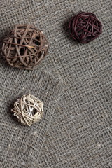 Coarse linen fabric. On it are rattan balls.