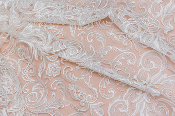 Fototapeta na wymiar Texture lace fabric. lace on white background studio. thin fabric made of yarn or thread. a background image of ivory-colored lace cloth. White lace on beige background.