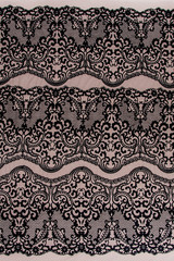 Texture lace fabric. lace on white background studio. thin fabric made of yarn or thread. a background image of ivory-colored lace cloth. Black lace on beige background.