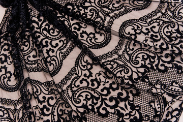 Texture lace fabric. lace on white background studio. thin fabric made of yarn or thread. a background image of ivory-colored lace cloth. Black lace on beige background.