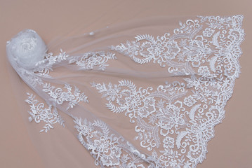Texture lace fabric. lace on white background studio. thin fabric made of yarn or thread. a background image of ivory-colored lace cloth. White lace on beige background.