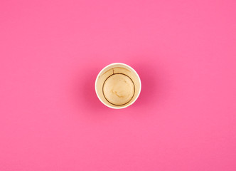 empty used red paper cup from under coffee