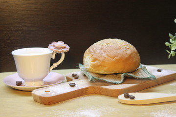cup of coffee and cookies on wooden table