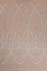 Texture lace fabric. lace on beige background studio. thin fabric made of yarn or thread. typically one of cotton or silk, made by looping, twisting, or knitting thread in patterns