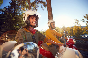 tourists woman and man traveling on motorcycle and having fun on vacation..