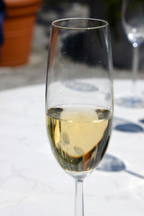 half full glass of champagne on table