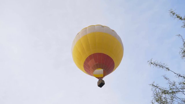 aerial view of hot air balloon flying over small village 4K