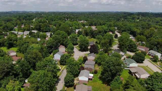 A forward moving aerial view flying above a typical middle class Pennsylvania residential neighborhood. Pittsburgh suburbs.  	