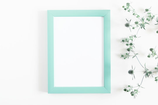 Beautiful flowers composition. Blank frame for text, flowers on white background. Flat lay, top view, copy space