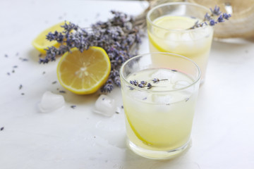 Tasty and fresh lavender lemonade on light background
