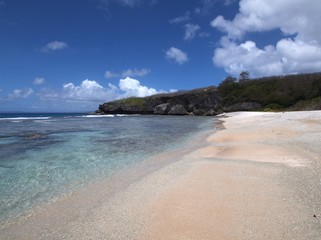 Fototapeta premium Scenic stretch of white sand and crystal-clear waters at Ladder Beach, Saipan