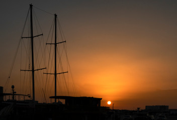 silhouette of ship at sunset