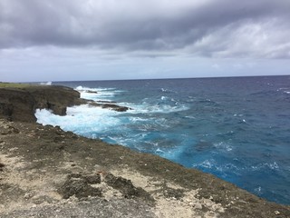 Rolling waves and rocky coastline at As Matmos Fishing Cliff, Rota, CNMI